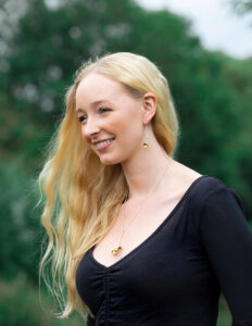 Model wearing horse pendant and snaffle earrings