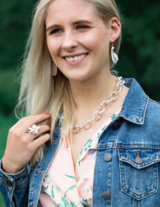 Modal wearing hydrangea ring and American oak chain