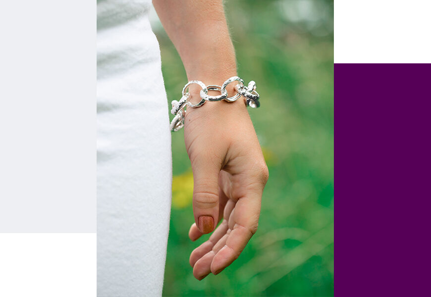 Model wearing belt her chain bracelet