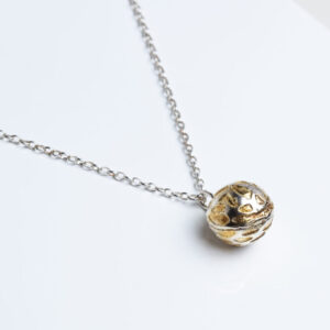 Silver ball pendant with textured surface and gold
