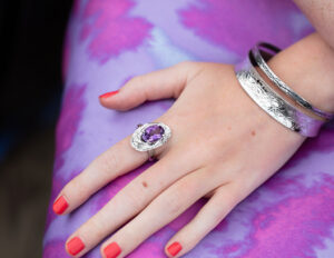 Modal wearing Amythist Cholla wood ring and two textured silver bangles