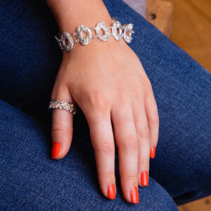 Modal wearing silver chunky cholla wood pattern bracelet and Quince texture ring