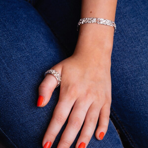 Model wearing handmade Sterling silver bracelet quince textured and ring