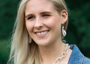 Model wearing sterling silver sycamore earrings and a chunky chain