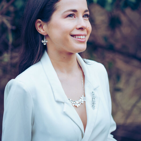 Model wearing silver Hydrangea necklace, brooch and earrings